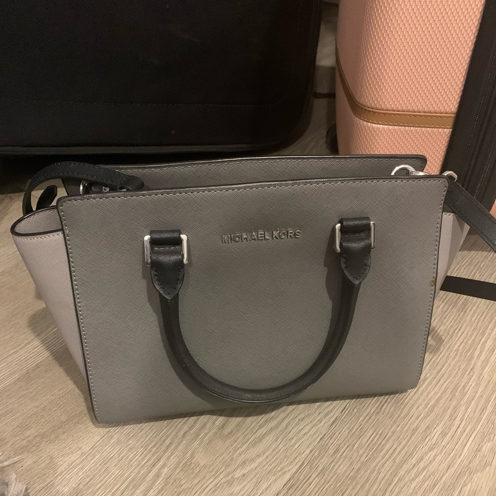 Michael Kors pocketbook; comes with a long strap